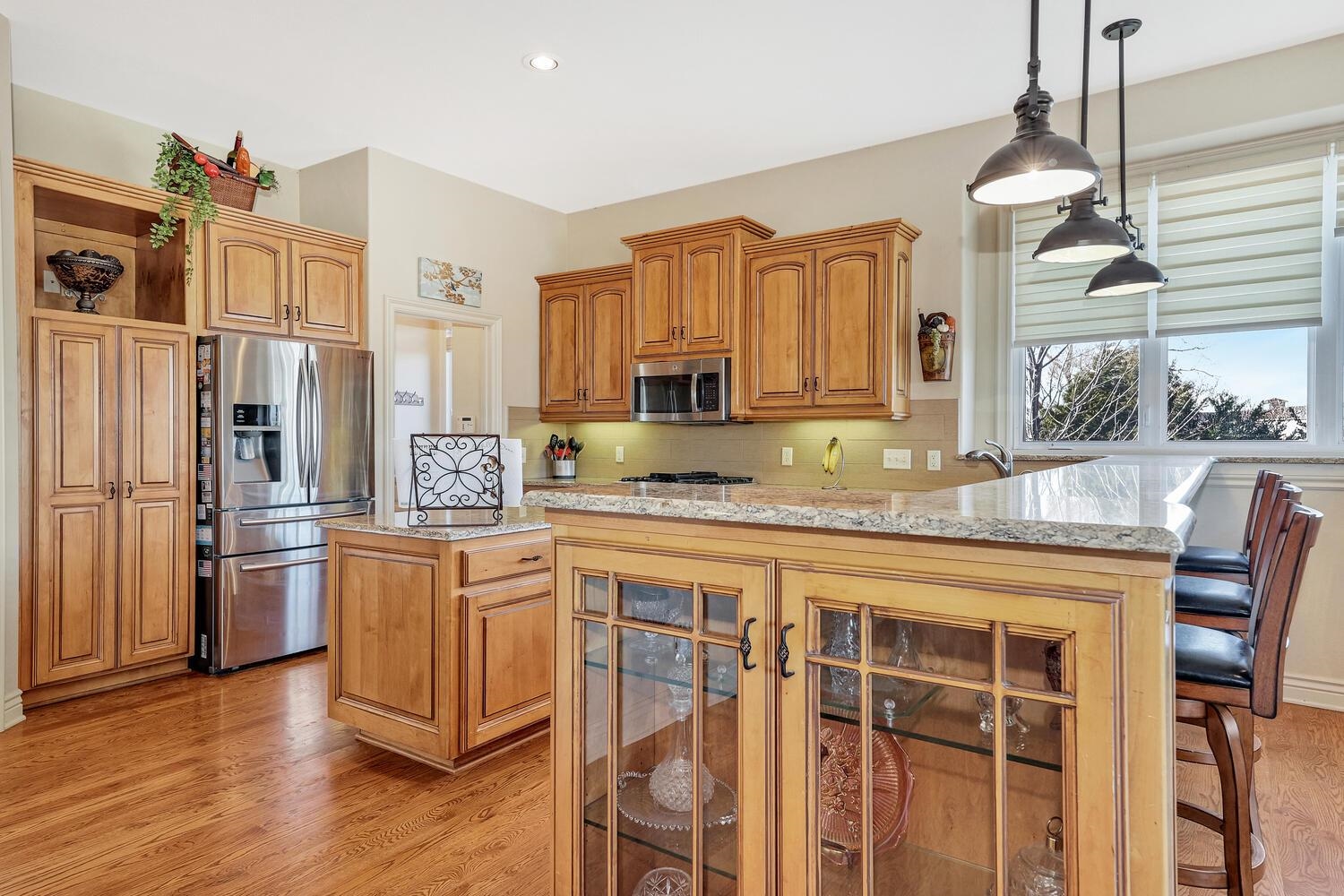13204 East Stampede Street Wichita, KS 67230 - Photo 11 of 35 The end of the eating bar has a lighted cabinet to show off your fancy dinner wear.