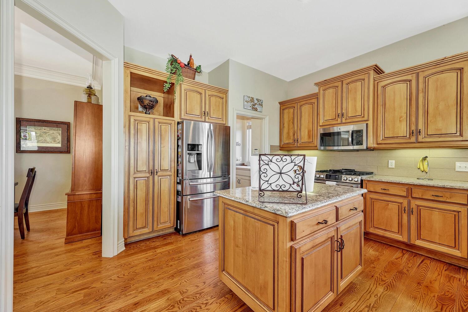 13204 East Stampede Street Wichita, KS 67230 - Photo 13 of 35 All kitchen appliances remain. Hardwood floors, granite counter tops. Island and wet bar with sink.