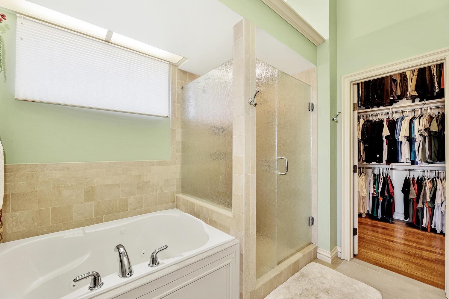 13204 East Stampede Street Wichita, KS 67230 - Photo 20 of 35 Separate jetted tub and large shower with glass door. Toilet is in a water closet. Door to closet is in the basement.