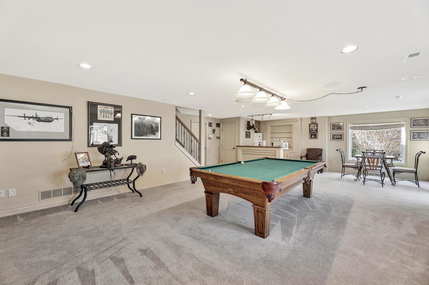 13204 East Stampede Street Wichita, KS 67230 - Photo 25 of 35 large room with wet bar and refrigerator remains, walk out basement with view out windows, gas fireplace.