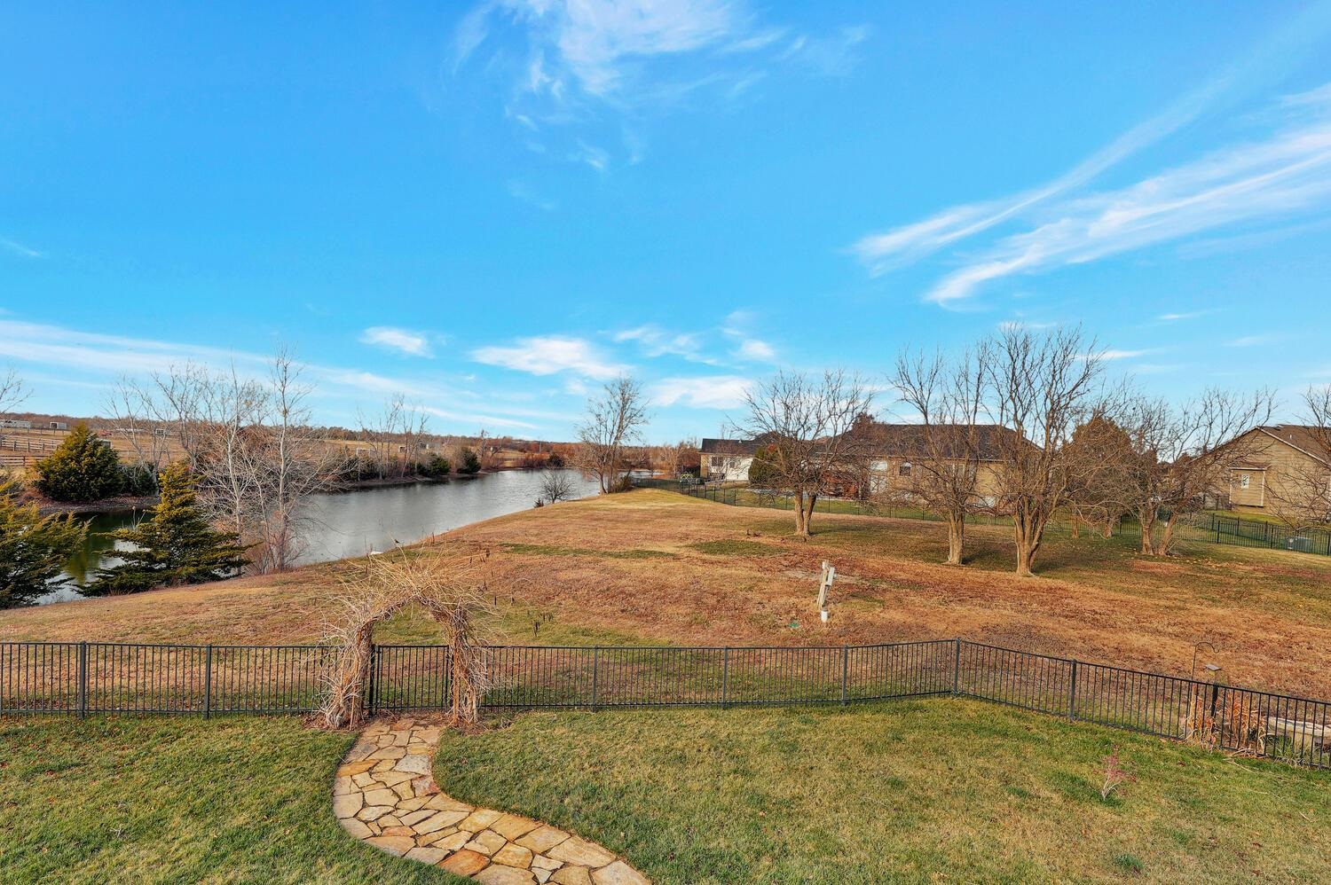 13204 East Stampede Street Wichita, KS 67230 - Photo 34 of 35 Take a walk out of the basement to the gate and around the lake.