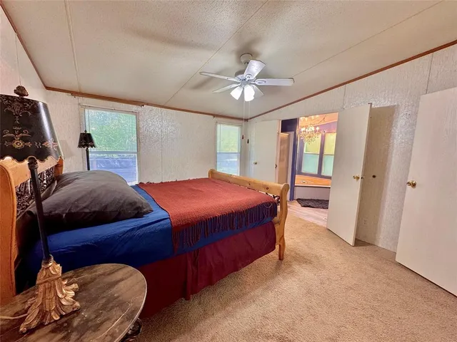 a bed sitting in a bedroom next to a window