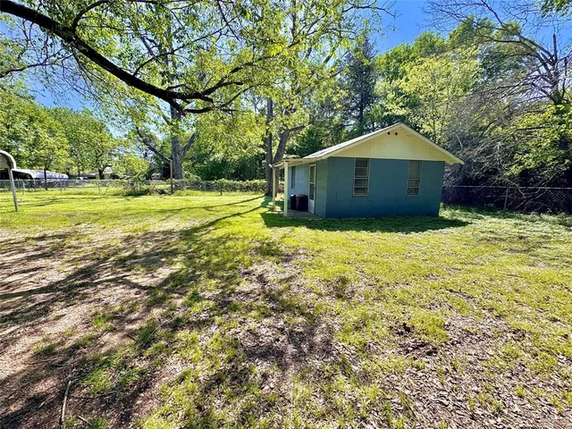 a yellow house with a yard