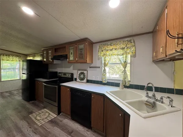 a kitchen with a sink appliances and cabinets