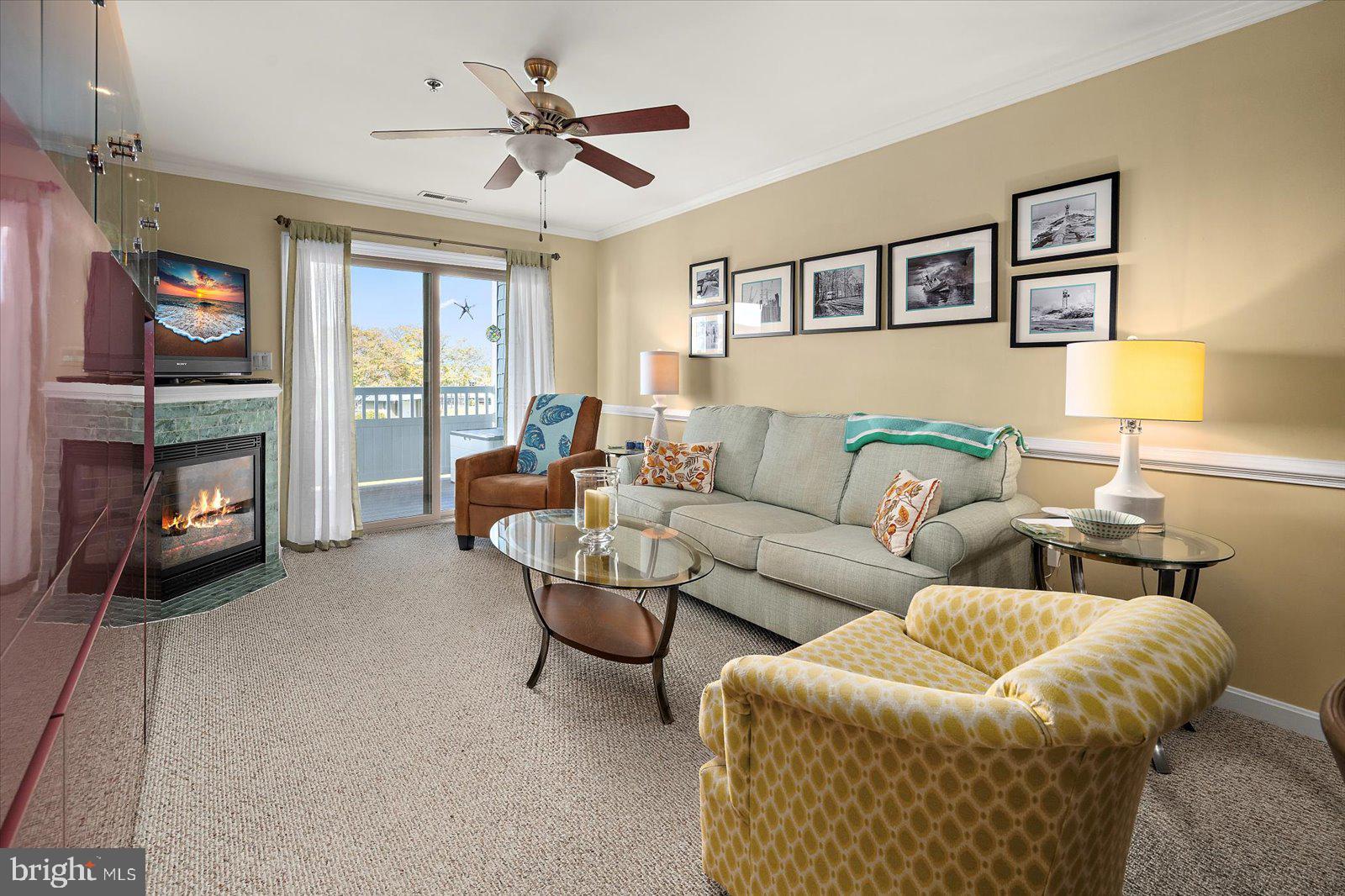 201 South Heron Drive, Unit 2D Ocean City, MD 21842 - Photo 11 of 61 a living room with furniture and a flat screen tv