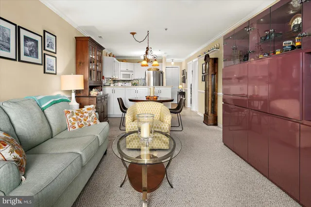 a living room with furniture and a chandelier