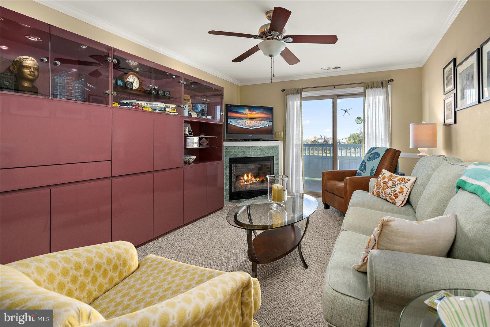 201 South Heron Drive, Unit 2D Ocean City, MD 21842 - Photo 13 of 61 a bedroom with a bed a couch and a flat tv screen