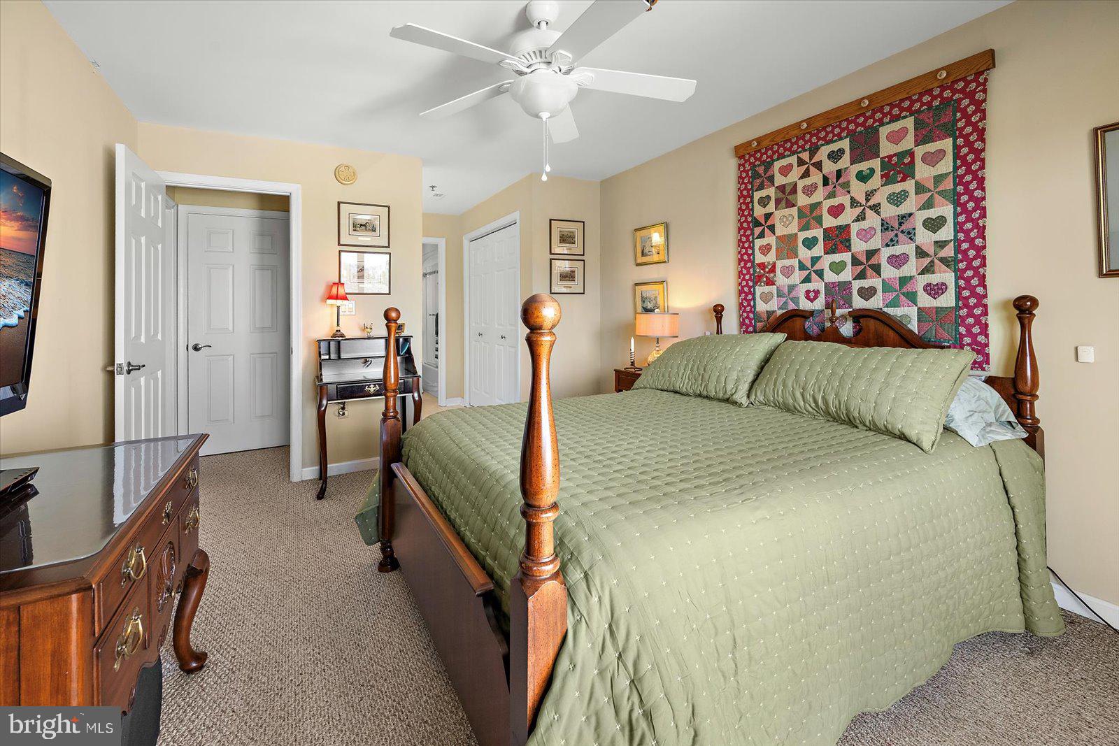 201 South Heron Drive, Unit 2D Ocean City, MD 21842 - Photo 16 of 61 a bedroom with a large bed and a chandelier