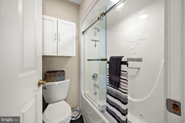 a white toilet sitting next to a bathroom sink