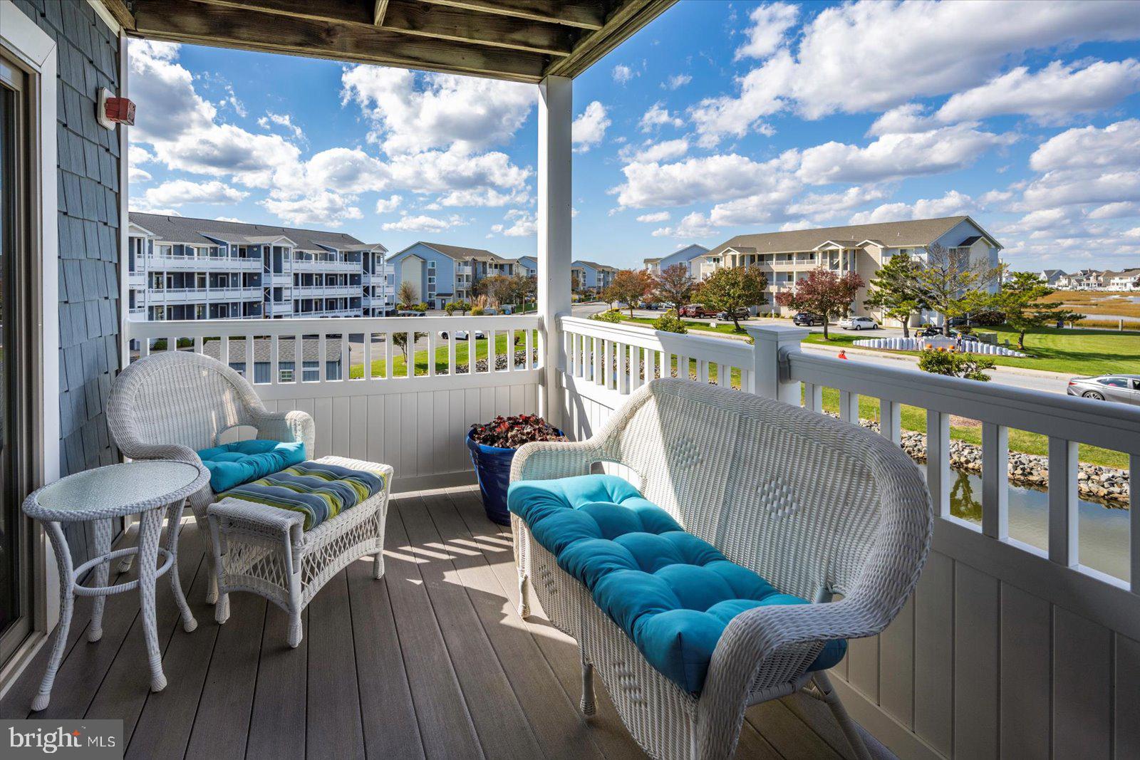 201 South Heron Drive, Unit 2D Ocean City, MD 21842 - Photo 28 of 61 a balcony with wooden floor and outdoor seating