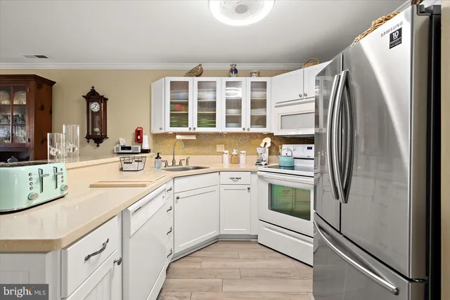 a kitchen with a refrigerator and a sink