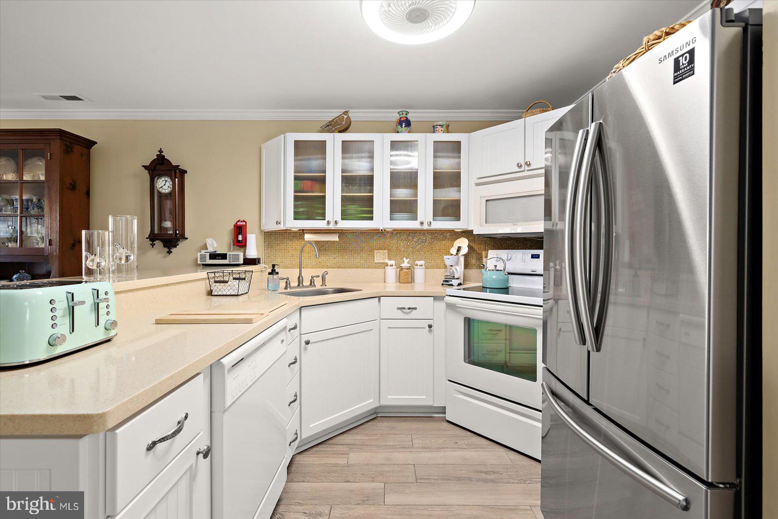 201 South Heron Drive, Unit 2D Ocean City, MD 21842 - Photo 3 of 61 a kitchen with a refrigerator and a sink