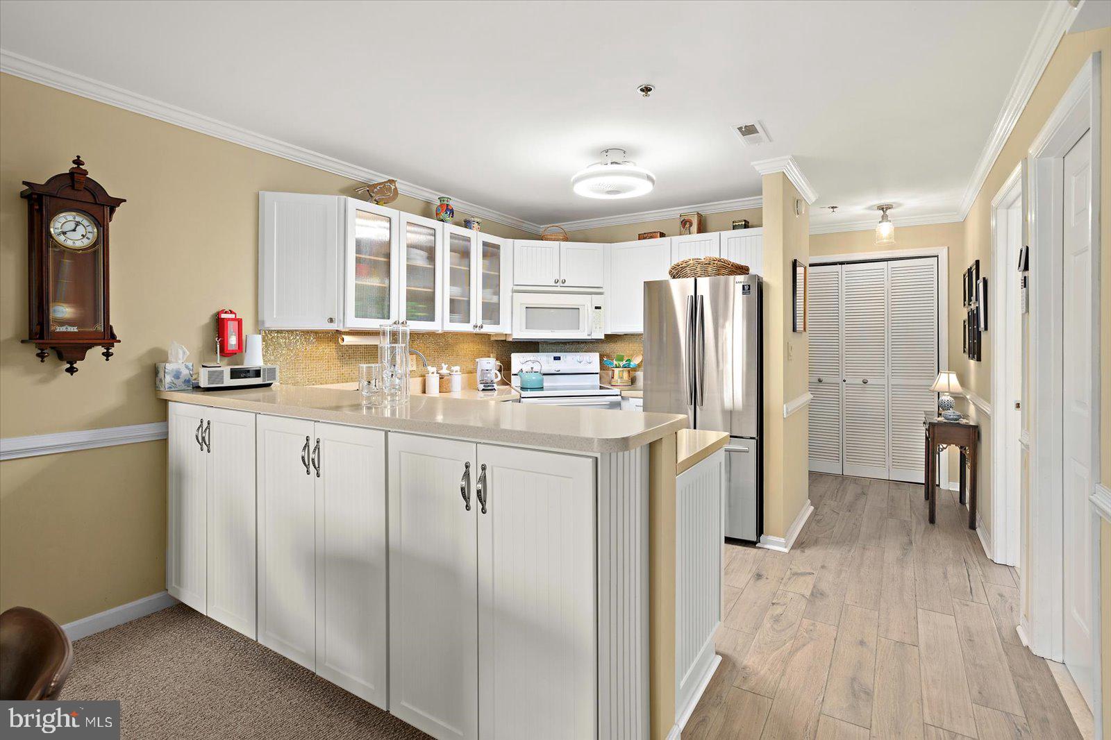 201 South Heron Drive, Unit 2D Ocean City, MD 21842 - Photo 4 of 61 a kitchen with refrigerator and window