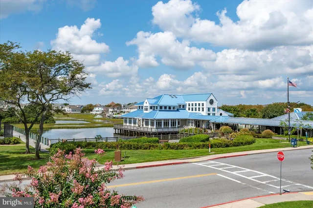 a view of a lake with houses in back