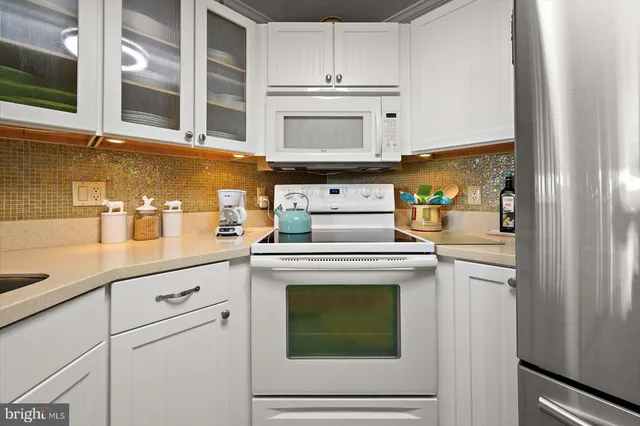 a kitchen with cabinets and stainless steel appliances