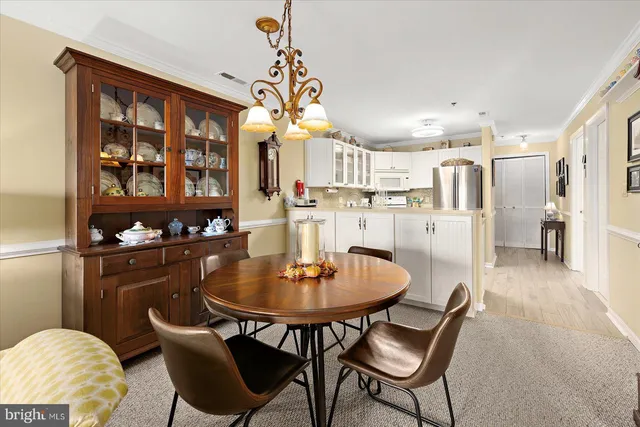 a view of a dining room with furniture and window