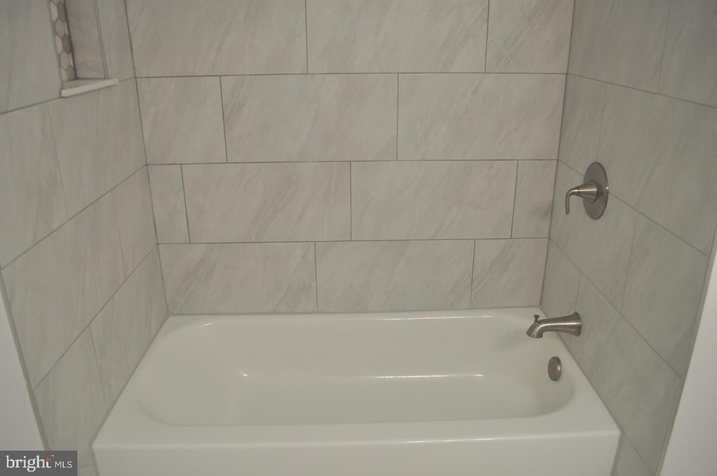 14613 Tynewick Terrace, Unit 61461 Silver Spring, MD 20906 - Photo 14 of 30 a bathroom with a bathtub