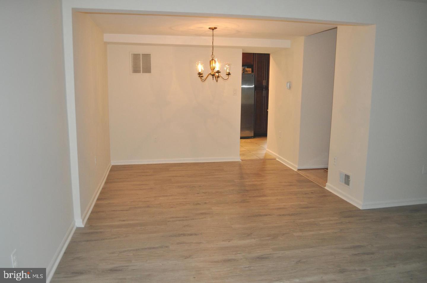 14613 Tynewick Terrace, Unit 61461 Silver Spring, MD 20906 - Photo 19 of 30 a view of a hallway with wooden floor