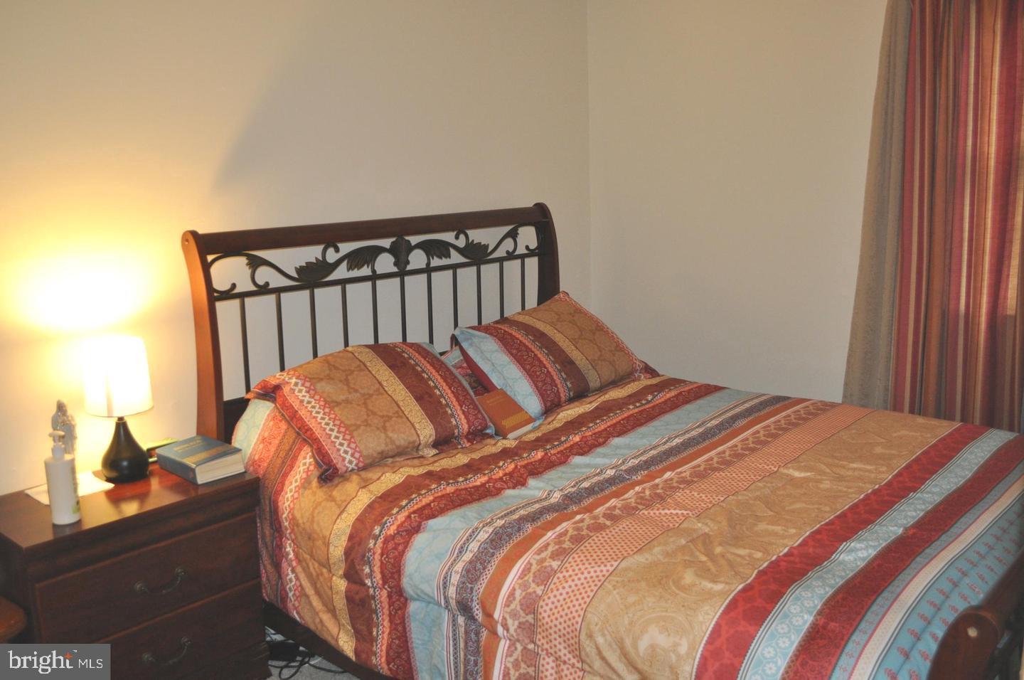 14613 Tynewick Terrace, Unit 61461 Silver Spring, MD 20906 - Photo 6 of 30 a bedroom with a bed and a window