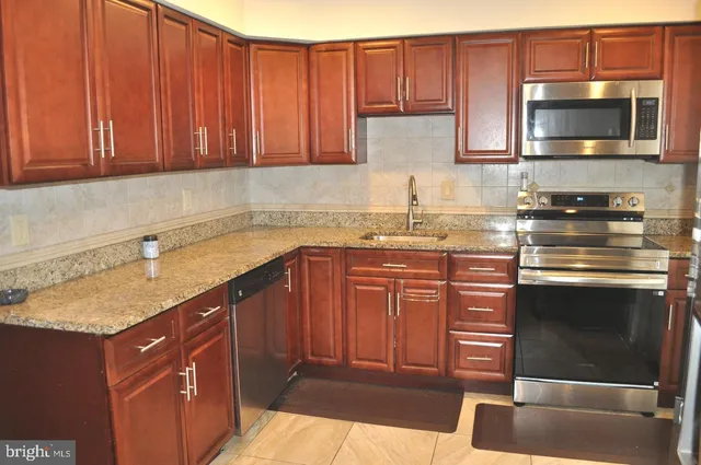 a kitchen with a sink and a stove top oven