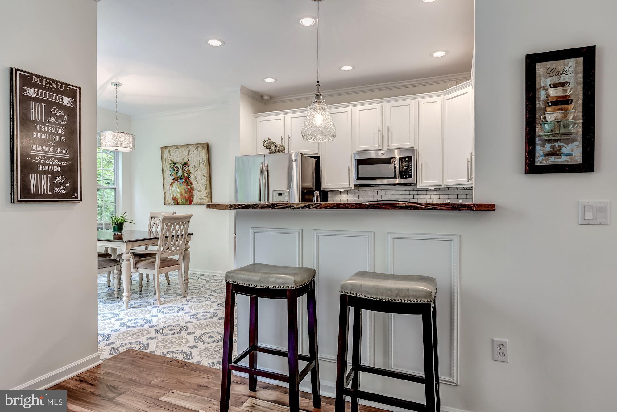 1205 Wild Hawthorn Way Reston, VA 20194 - Photo 22 of 53 Designer lighting enhances the kitchen