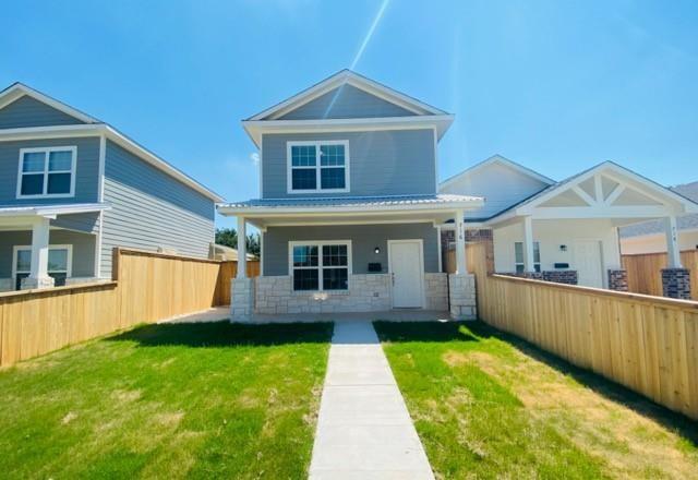 716 South Main Street, Unit 718 McGregor, TX 76657 - Photo 1 of 12 a front view of house with yard and green space