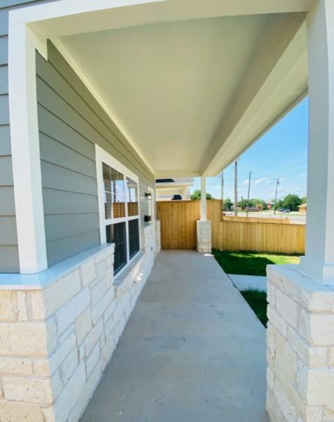 716 South Main Street, Unit 718 McGregor, TX 76657 - Photo 12 of 12 a view of a porch with plants and large trees