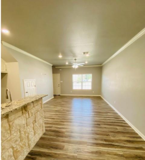 716 South Main Street, Unit 718 McGregor, TX 76657 - Photo 2 of 12 a view of a room with wooden floor and staircase
