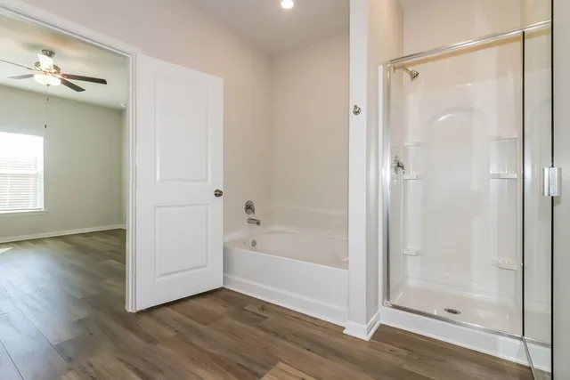a bathroom with a bathtub and a shower