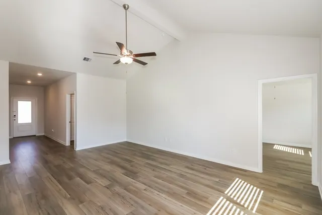 wooden floor in an empty room with a window
