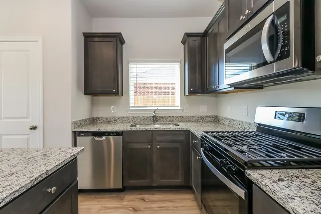 a kitchen with a stove and a sink