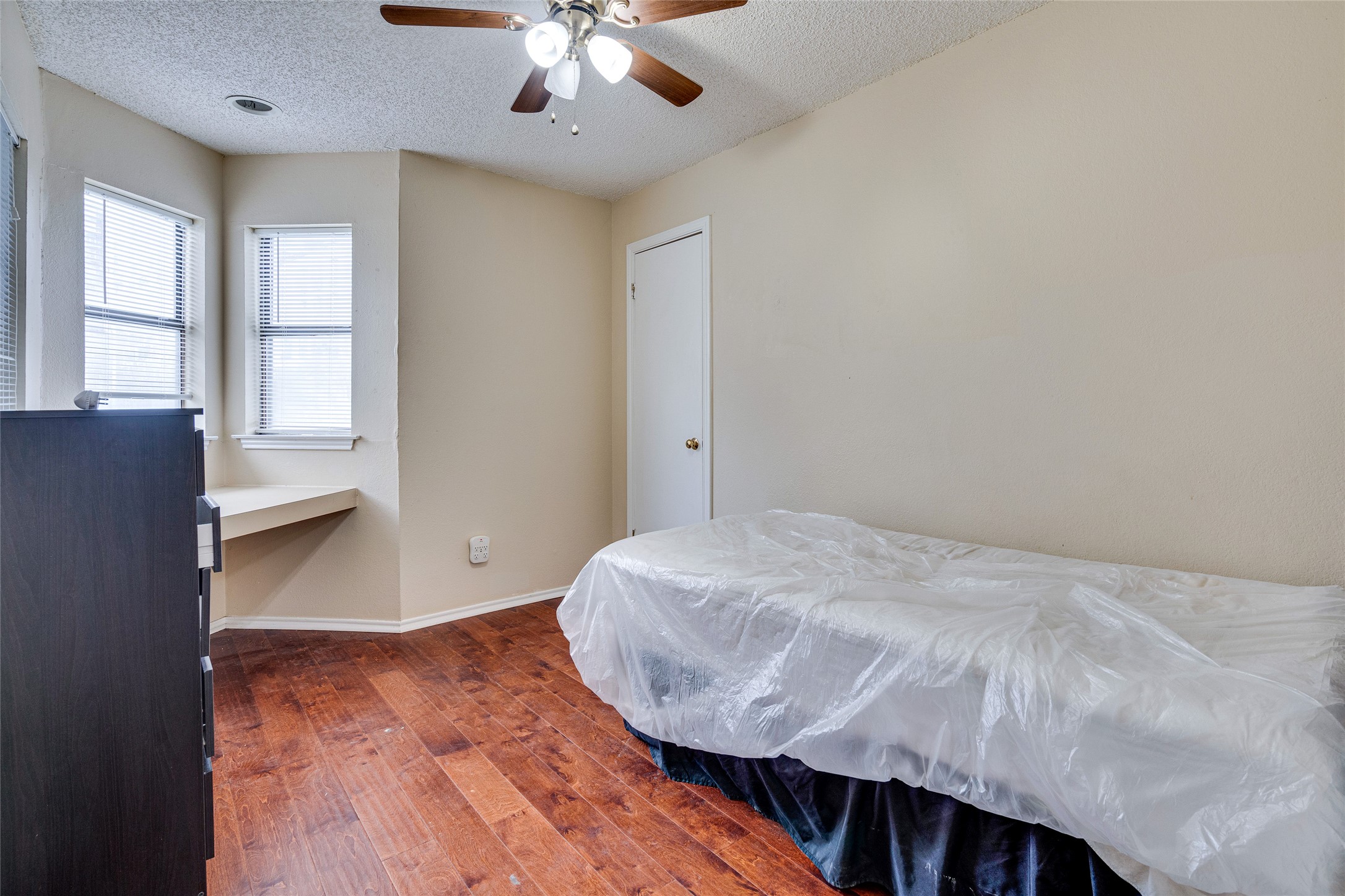 1808 Rio Grande Street, Unit 6 Austin, TX 78701 - Photo 23 of 29 Bedroom with dark wood-style flooring, a textured ceiling, and ceiling fan