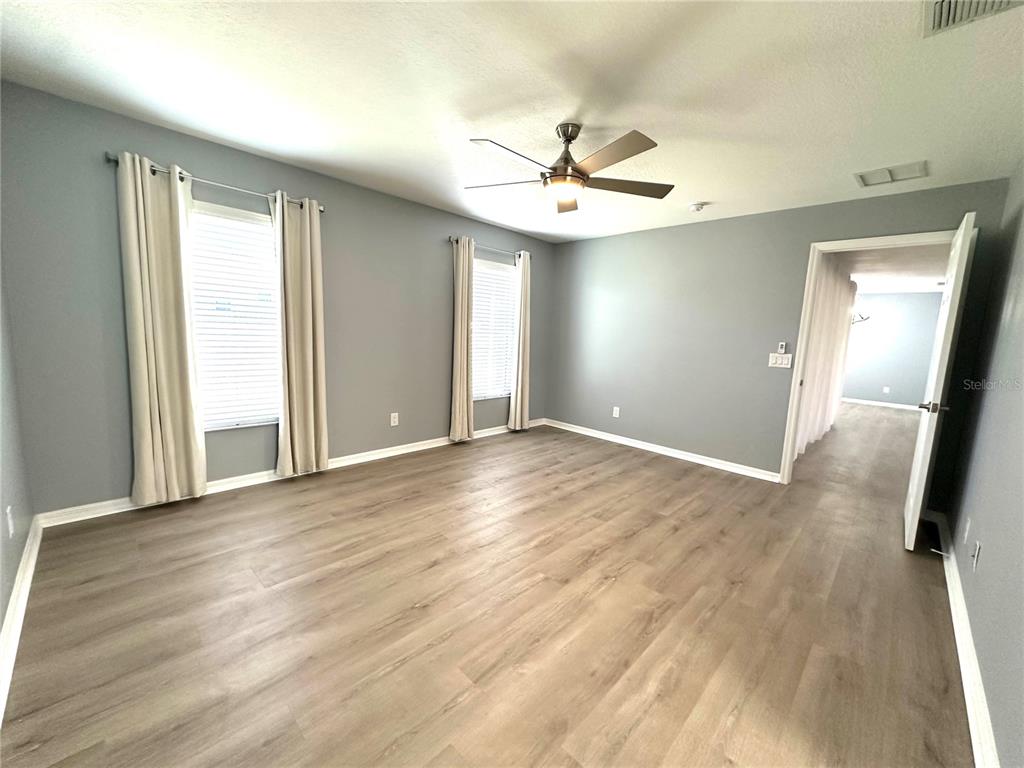 9706 Southwest 92nd Place Road Ocala, FL 34481 - Photo 12 of 82 wooden floor in an empty room with a window