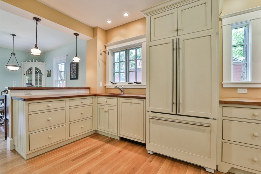14 Still River Road Harvard, MA 01451 - Photo 11 of 39 a kitchen with white cabinets and stainless steel appliances