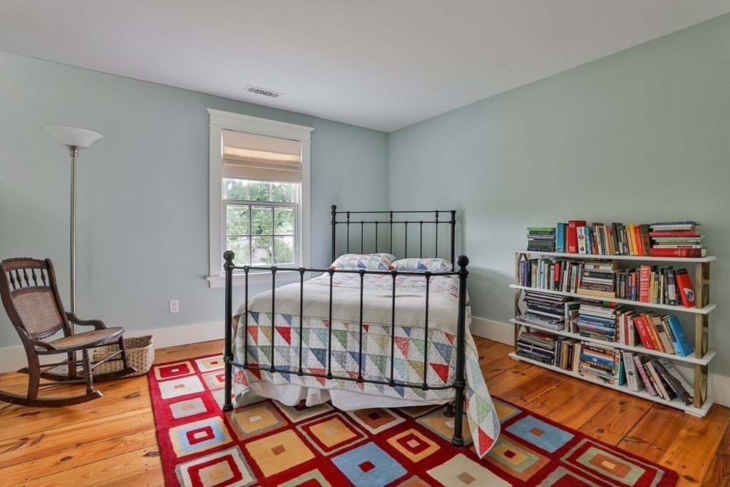 14 Still River Road Harvard, MA 01451 - Photo 28 of 39 a bedroom with furniture and a book shelf