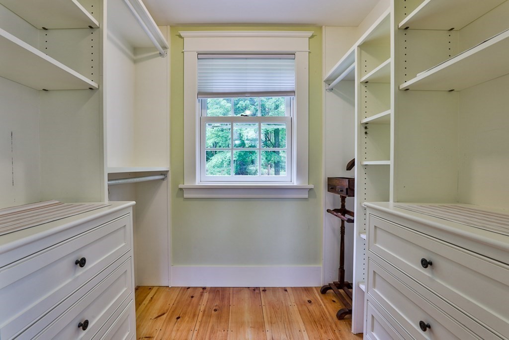 14 Still River Road Harvard, MA 01451 - Photo 33 of 39 a view of walk in closet with wooden floor and cabinet