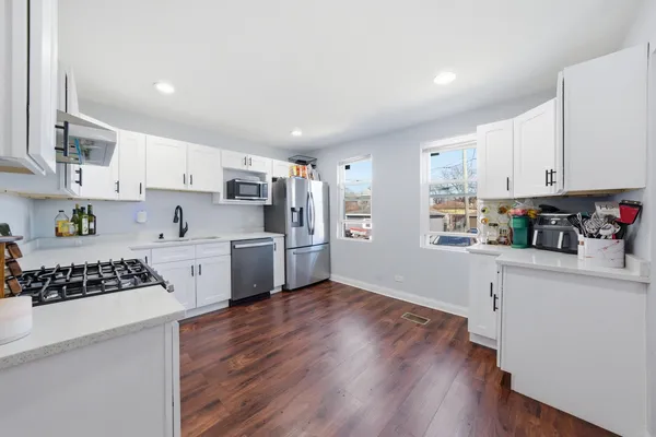 a kitchen with stainless steel appliances a refrigerator sink and cabinets