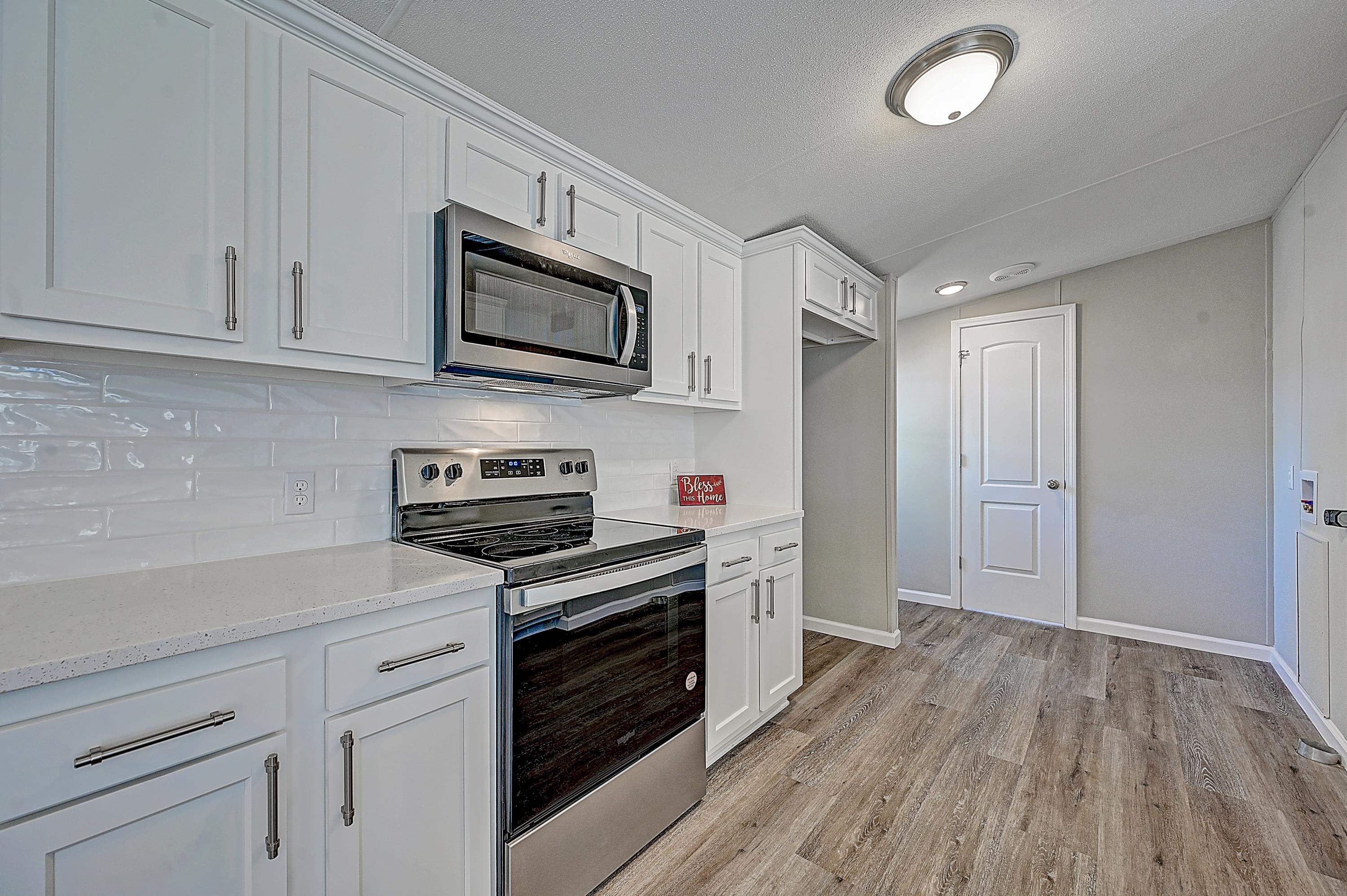 800 Oakes Avenue St. Augustine, FL 32084 - Photo 13 of 26 a kitchen with stainless steel appliances granite countertop a stove a sink and a microwave