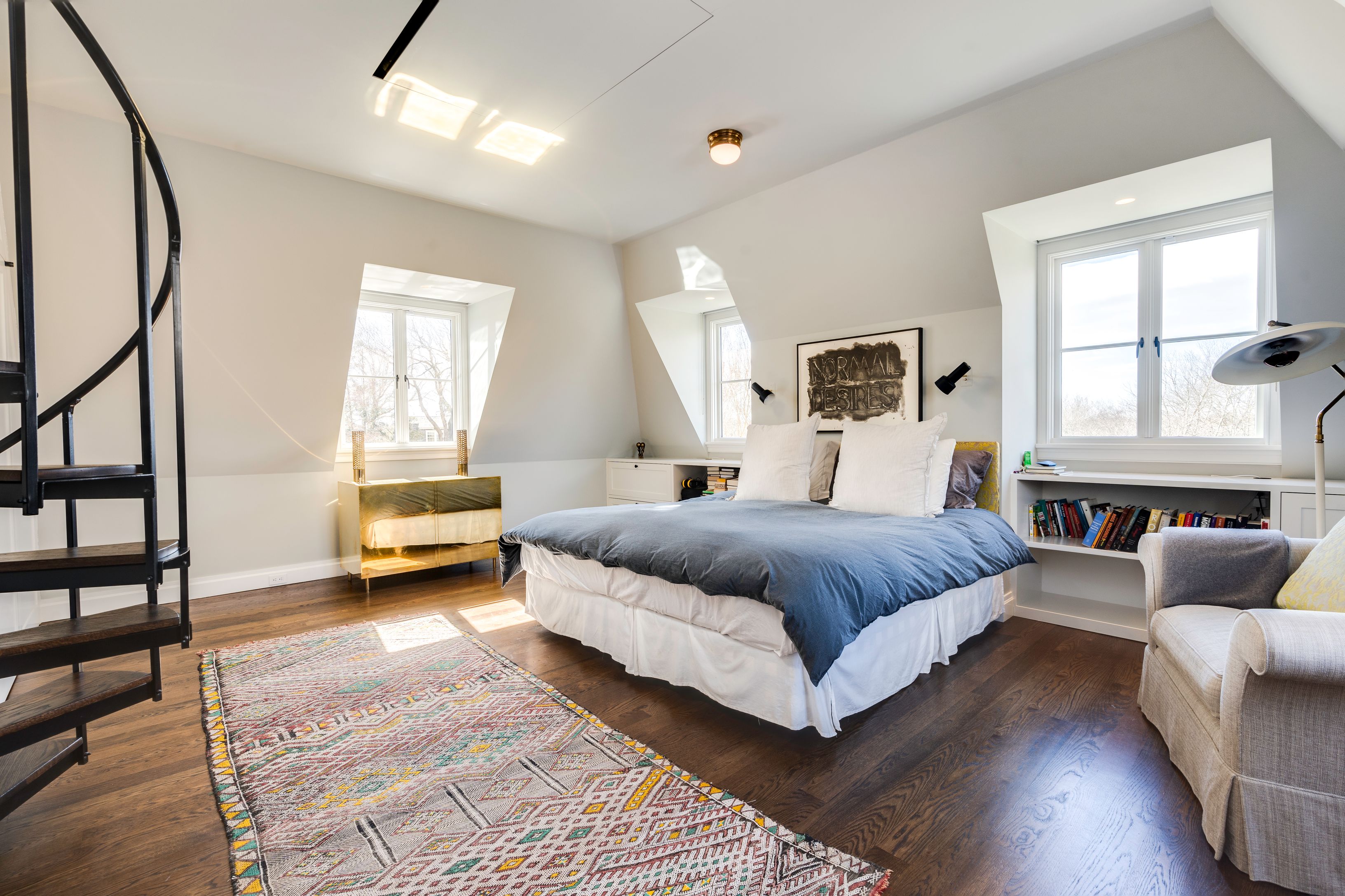 153 Egypt Lane East Hampton, NY 11937 - Photo 23 of 47 a spacious bedroom with a bed couch and a window