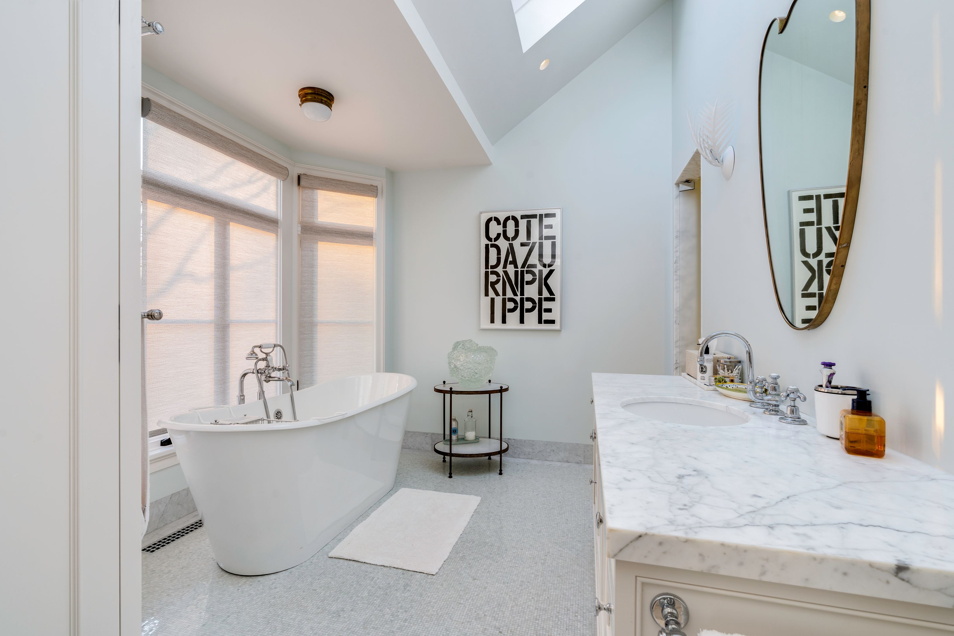 153 Egypt Lane East Hampton, NY 11937 - Photo 36 of 47 a bathroom with a tub sink and mirror