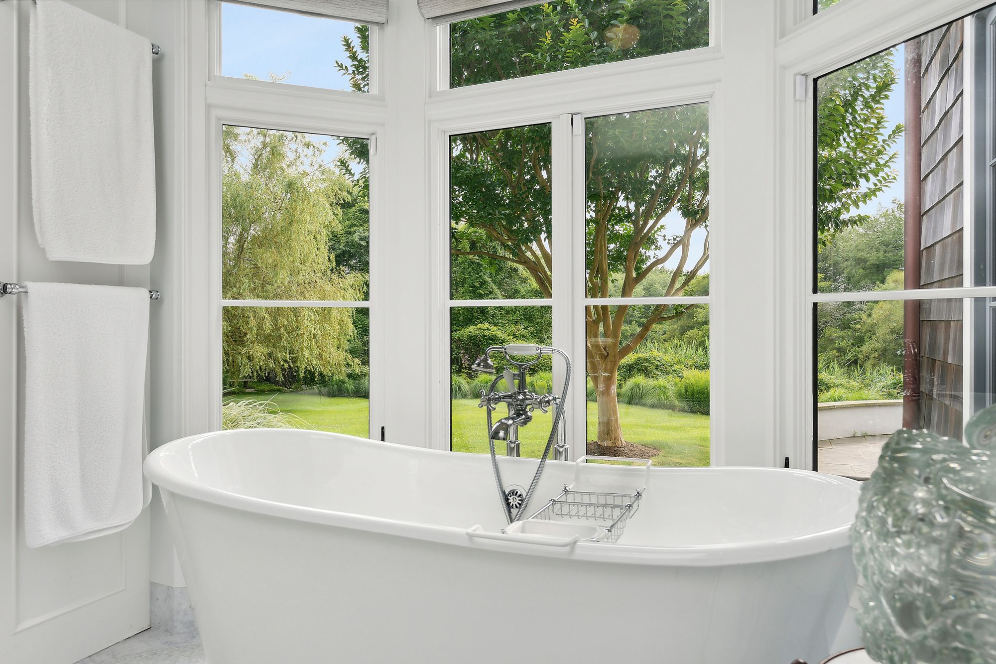 153 Egypt Lane East Hampton, NY 11937 - Photo 37 of 47 a white bath tub sitting in front of a window