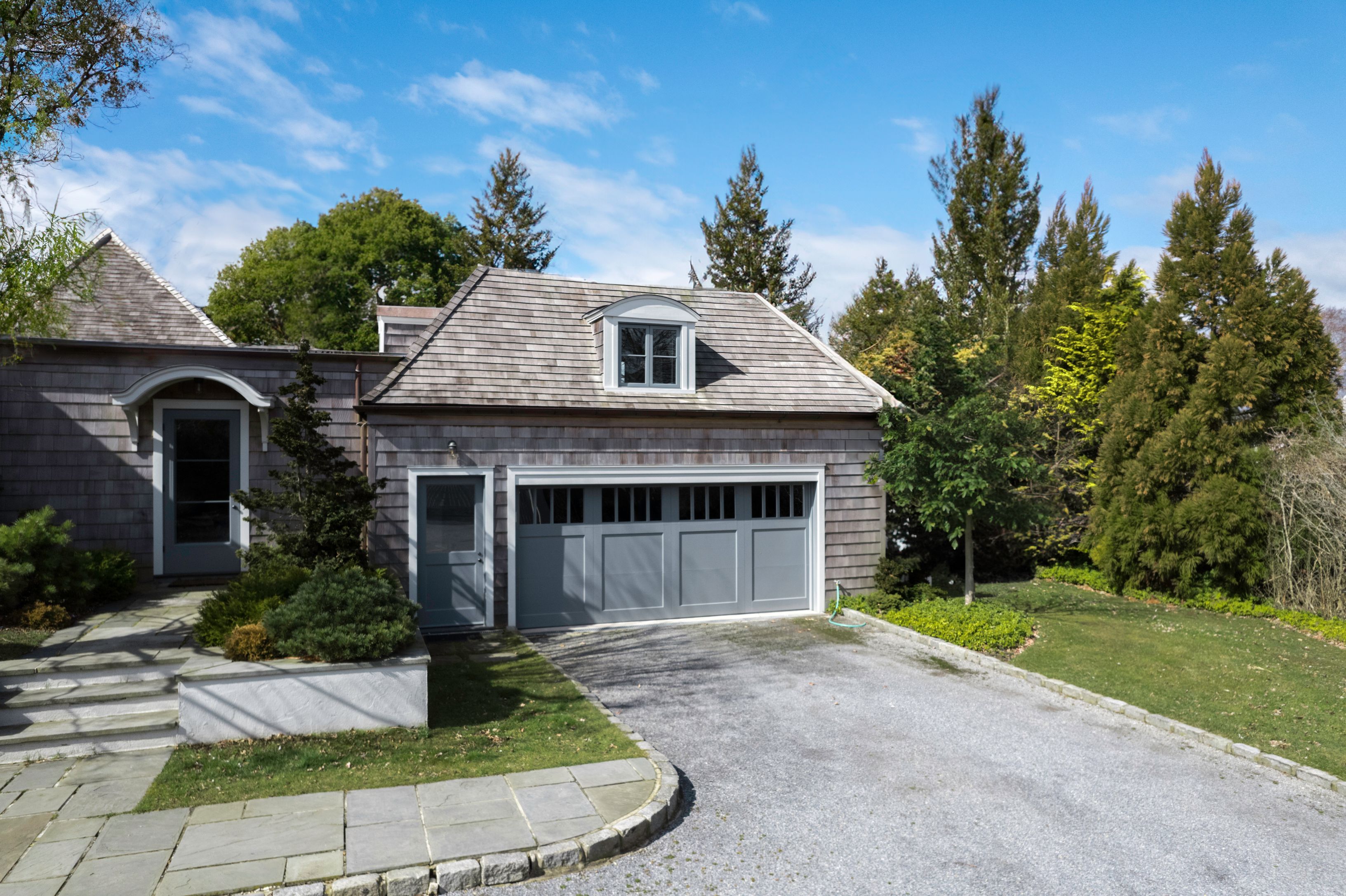153 Egypt Lane East Hampton, NY 11937 - Photo 40 of 47 a front view of a house with a yard