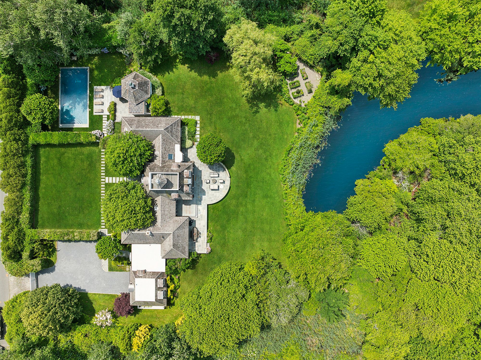153 Egypt Lane East Hampton, NY 11937 - Photo 6 of 47 an aerial view of a house with outdoor space swimming pool and lake view