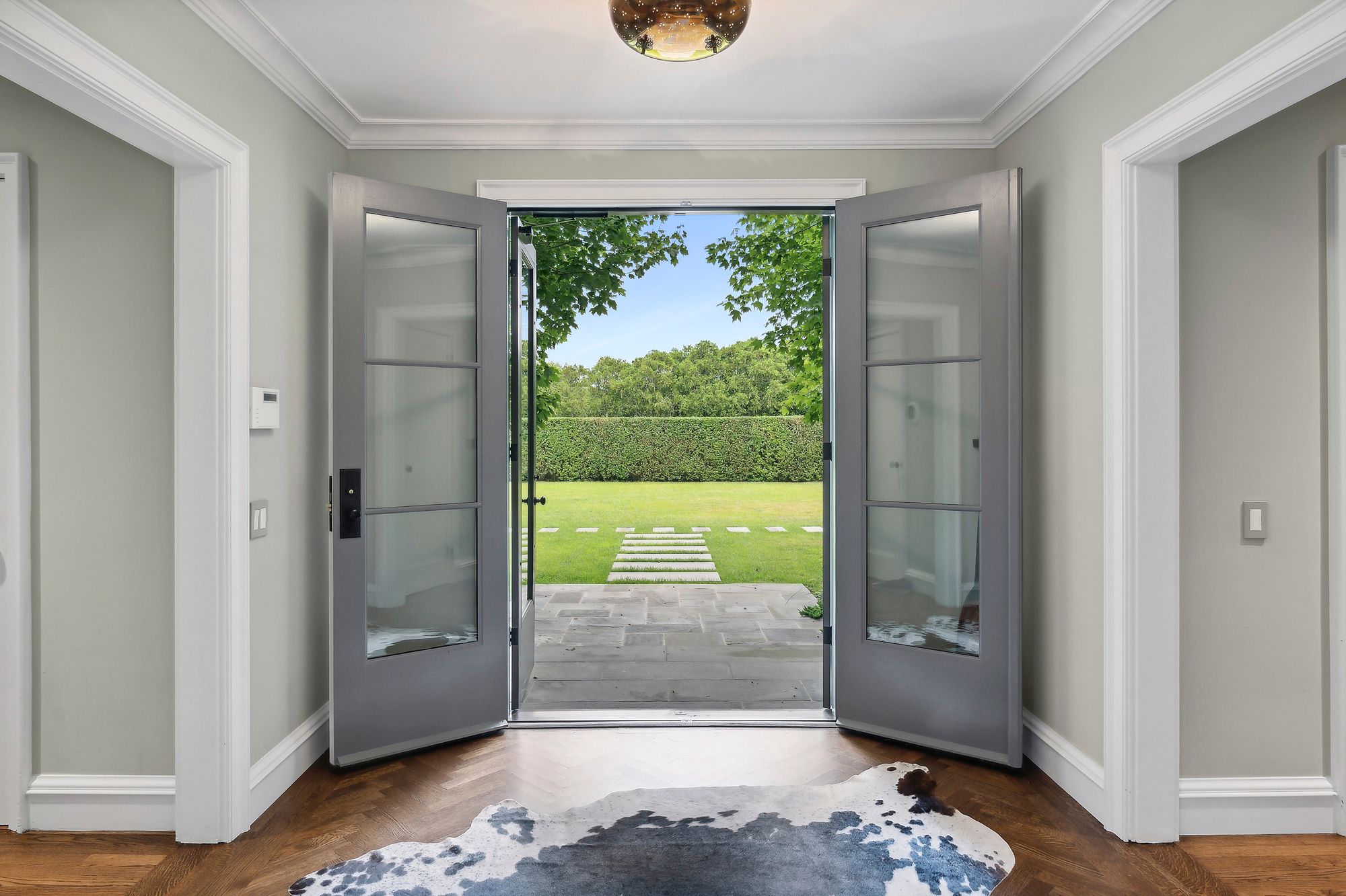 153 Egypt Lane East Hampton, NY 11937 - Photo 8 of 47 a view of a bedroom with a large bed and wooden floor