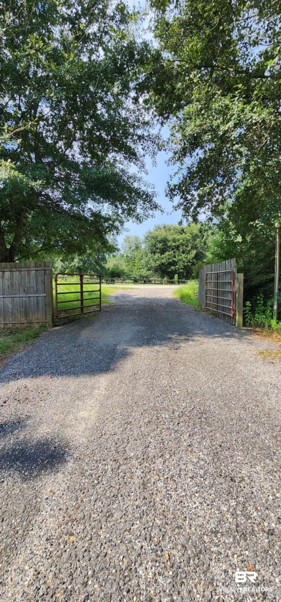 29049 Loper Road Loxley, AL 36551 - Photo 23 of 23 View of dirt / gravel driveway with a gate and a gated entry