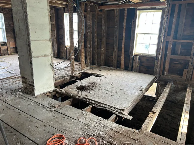 a living room with hard wood flooring and furniture