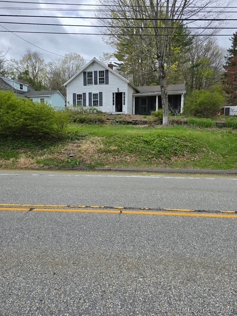 297 Main Street Hampton, CT 06247 - Photo 2 of 16 a front view of a house with a yard and garage
