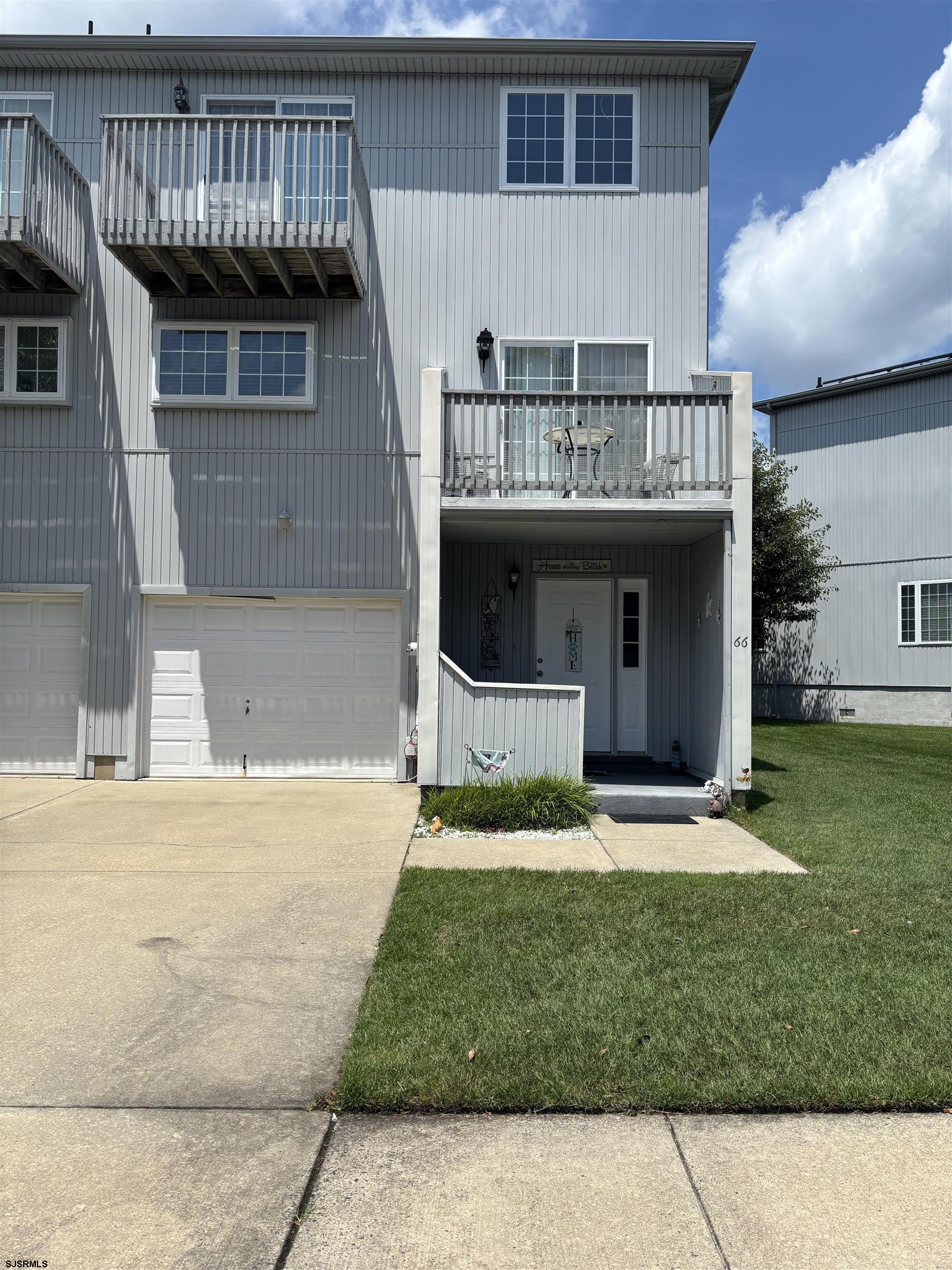 66 Sailfish Drive Brigantine, NJ 08203 - Photo 1 of 24 a front view of a house with a garden and yard