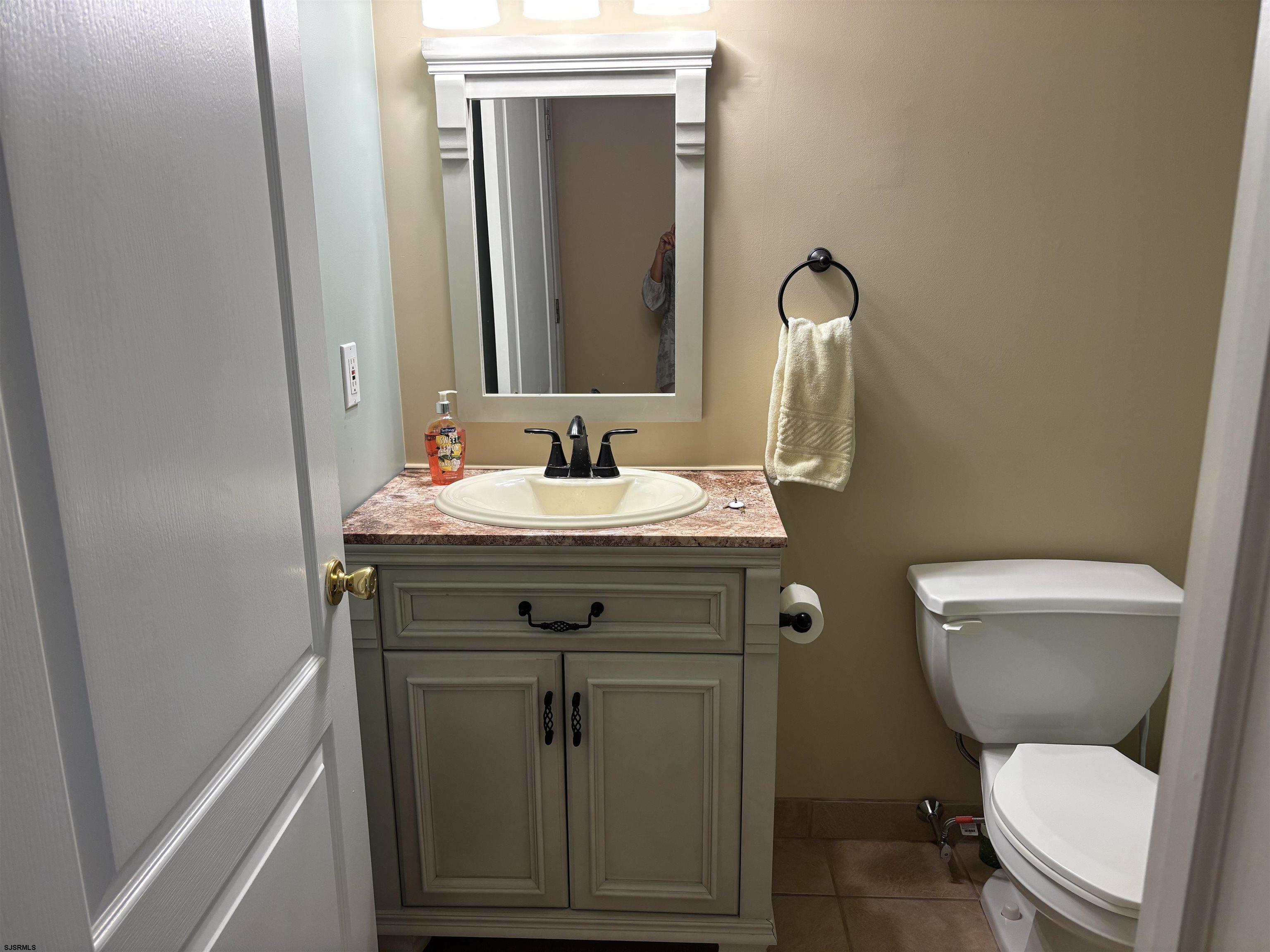 66 Sailfish Drive Brigantine, NJ 08203 - Photo 9 of 24 a bathroom with a toilet sink and mirror
