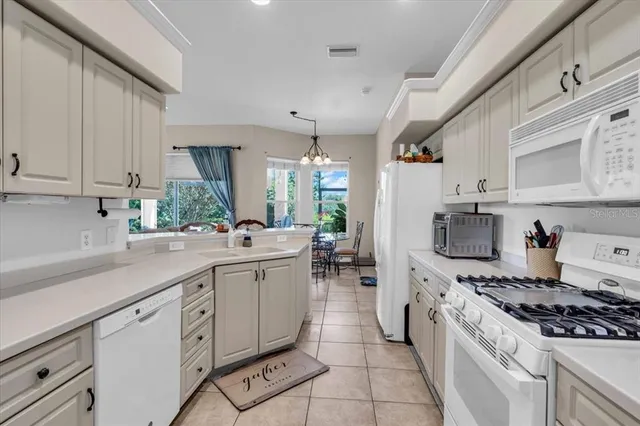 a kitchen with appliances a sink and cabinets